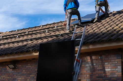 workers-installing-solar-panel-on-roof-of-resident-2026-03-25-03-55-13-utc